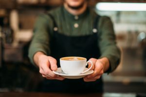 person serving coffee cup